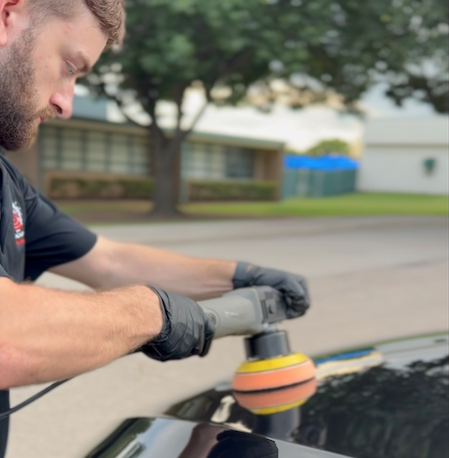 Alex from Detail Daddy machine polishing a vehicle's paint
